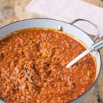 Traditional Bolognese sauce simmering with tomatoes and wine