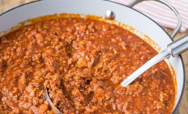 Traditional Bolognese sauce simmering with tomatoes and wine