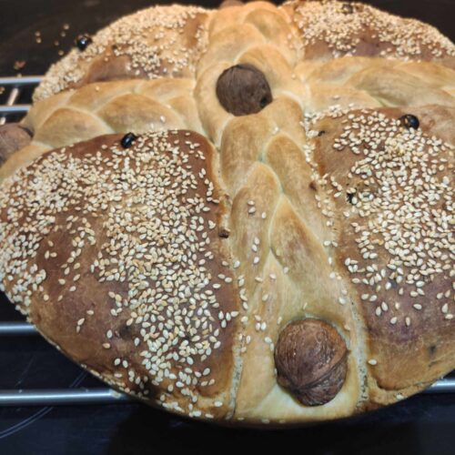 Christopsomo (Traditional Greek Christmas Bread) baked with braids and whole walnuts