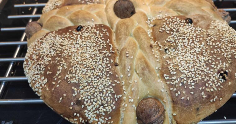 Christopsomo (Traditional Greek Christmas Bread) baked with braids and whole walnuts