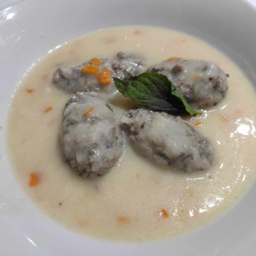Giouvarlakia Greek Meatball Soup is made with beef.pork in a egg lemon sauce
