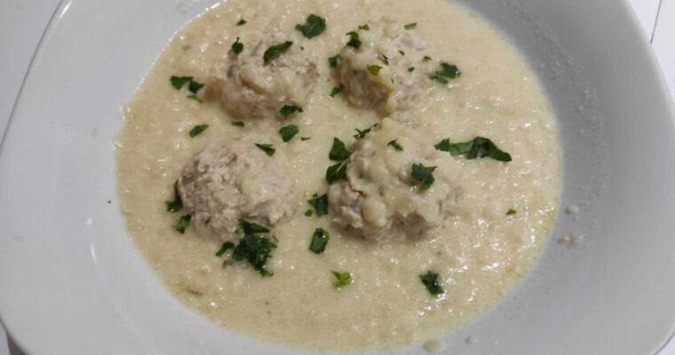 Traditional Greek Giouvarlakia with Chicken and Trahana soup served warm in a rustic bowl