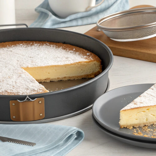 Traditional Italian Cheesecake with ricotta filling, digestive biscuit base, and citrus zest topping, served on a white plate.